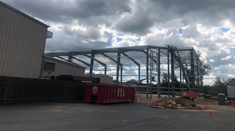 The new two-story storage building exterior construction at LaComedia Dinner Theater, 765 W. Central Ave., Springboro, is expected to be completed sometime in October. Once the exterior is completed, the current storage building will be demolished so contractors can complete the interior of the new building. RICK McCRABB/STAFF