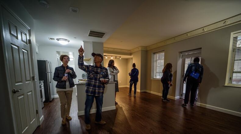 People tour downtown Dayton townhomes as part of the Downtown Housing Tour. TOM GILLIAM / CONTRIBUTING PHOTOGRAPHER