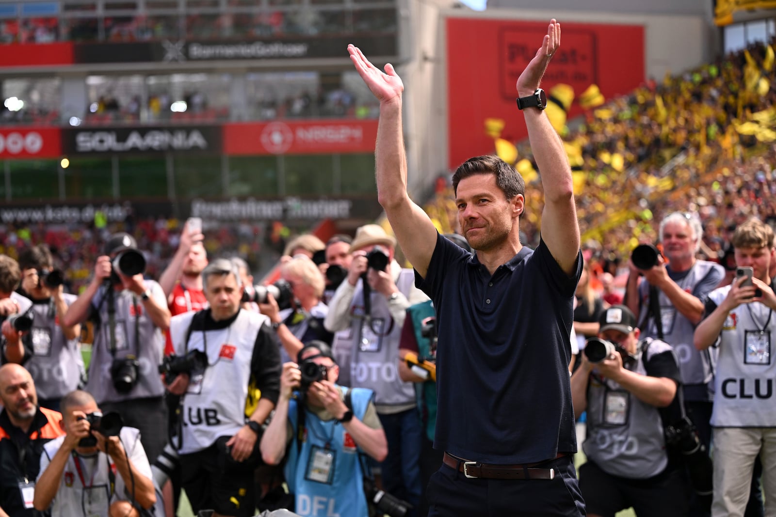 Leverkusen's head coach Xabi Alonso waves to the fans before the German Bundesliga soccer match between Bayer 04 Leverkusen and Borussia Dortmund in Leverkusen, Germany, Sunday, May 11, 2025. (Marius Becker/dpa via AP)