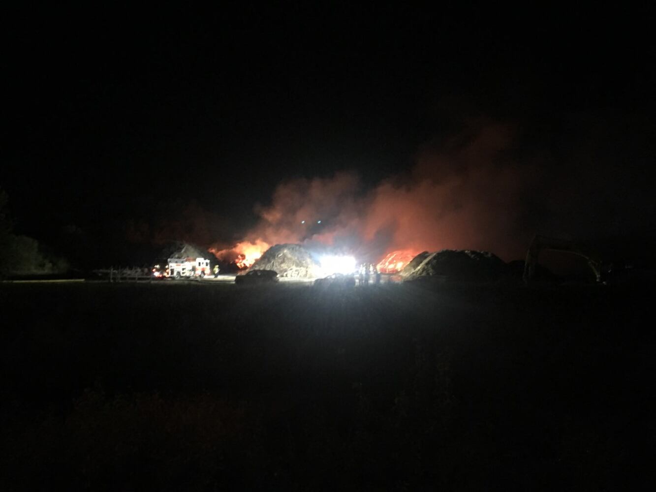 Fire crews battling huge fire in wood piles on Harshman Road