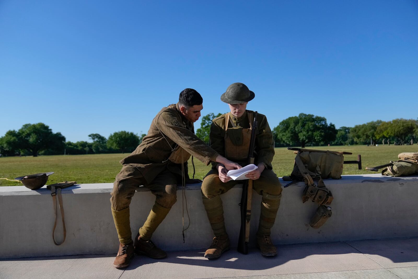 Members of the Army military, Joe Galli, left, and Michael Doblosky, right, prepare for a ceremony at Fort Benning, honoring new namesake on Wednesday, April 16, 2025, in Fort Benning, Ga. (AP Photo/Brynn Anderson)