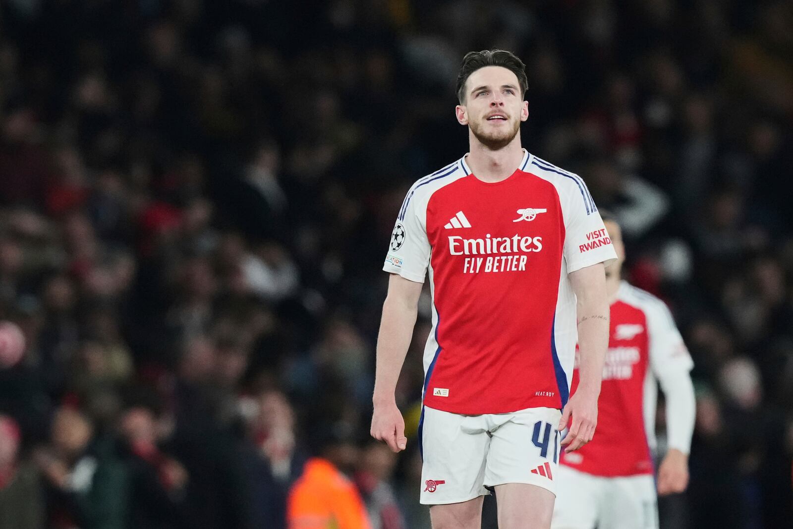 Arsenal's Declan Rice celebrates after scoring his side's opening goal during the Champions League quarterfinal first leg soccer match between Arsenal and Real Madrid at the Emirates Stadium in London, Tuesday, April 8, 2025. (AP Photo/Frank Augstein)