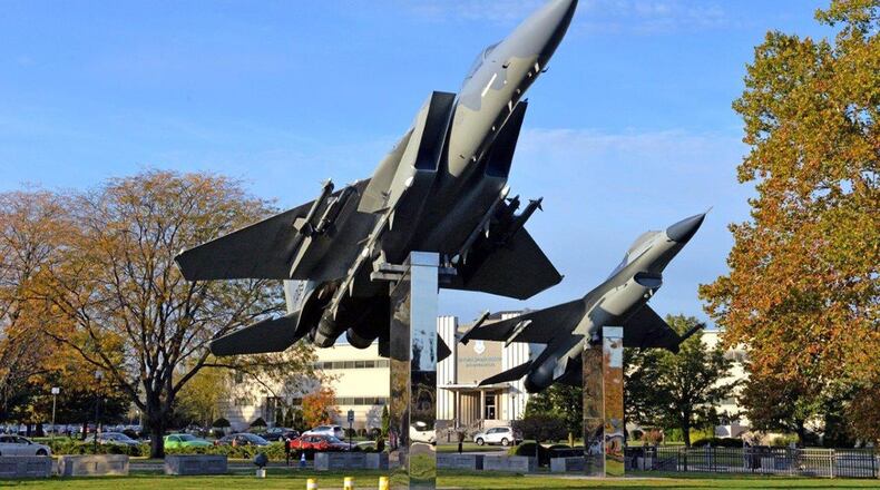 An F-16 and F-15 on display in the autumn sun outside of Air Force Materiel Command headquarters on Wright-Patterson Air Force Base. As the fiscal year wraps ups, the command took a look back on this year’s accomplishments. (U.S. Air Force photo/Al Bright)
