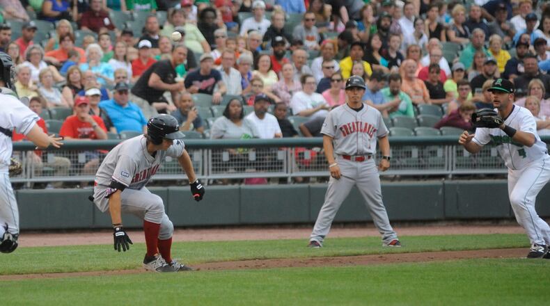 Dragons catcher Cassidy Brown (left) and third baseman John Sansone catch Mitchell Hansen in a rundown. The Dragons lost 8-3 to the visiting Great Lakes Loons (Dodgers) at Dayton’s Fifth Third Field on Thursday, June 15, 2017. MARC PENDLETON / STAFF