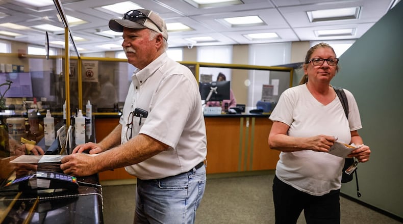 Washington Township farmer, Joe Turner pays his property tax a day before the tax is due at the Montgomery County Treasurer Office at the Montgomery County Administration building on West Third Street in Dayton. Turner said he pays his taxes in person because his father told him to make sure the clerks stamp the paperwork. JIM NOELKER/STAFF
