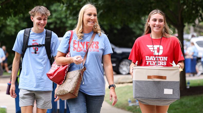 University of Dayton students and family members move items into Marycrest Hall, one of the main freshmen dorms on campus, on Friday, Aug. 22. The university is welcoming about 1,700 freshmen this weekend. BRYANT BILLING / STAFF