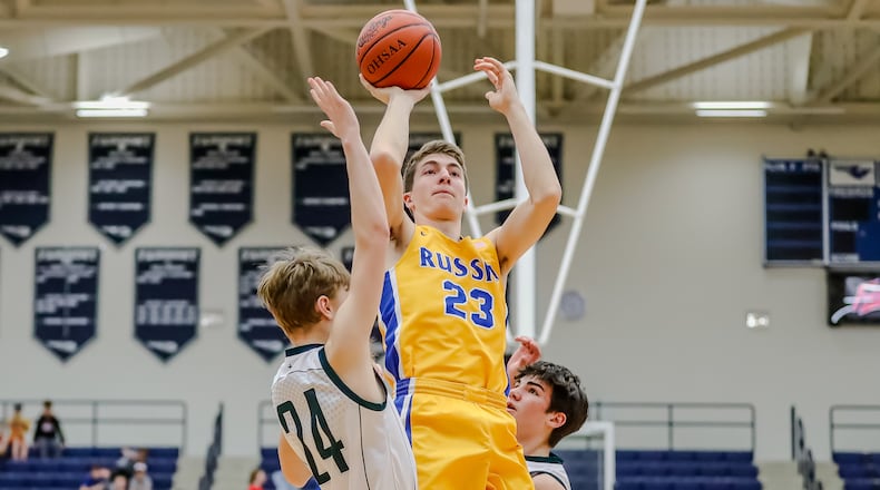 Russia High School's Benjamin York shoots over two Lancaster Fisher Catholic defenders during a Division IV regional semifinal game last season at Trent Arena in Kettering. The Raiders won 71-20. CONTRIBUTED PHOTO BY MICHAEL COOPER