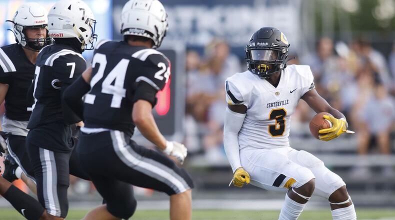 Centerville's Reggie Powers carries the ball during their 9-6 win over Lakota East Friday, Aug. 19, 2022 at Lakota East High School in Liberty Township. NICK GRAHAM/STAFF