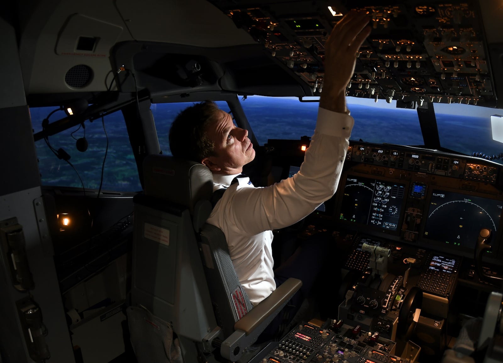 Capt. Miles Morgan, managing director of flight training for United Airlines, flies a simulator at the company's training campus in Denver, Friday, May 16, 2025. (AP Photo/Thomas Peipert)