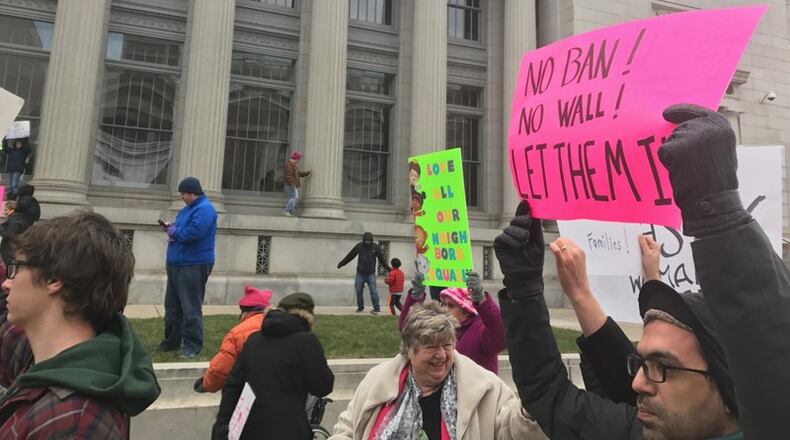 Protesters held signs condemning the executive order by President Trump and to show support for those impacted. TREMAYNE HOGUE / STAFF