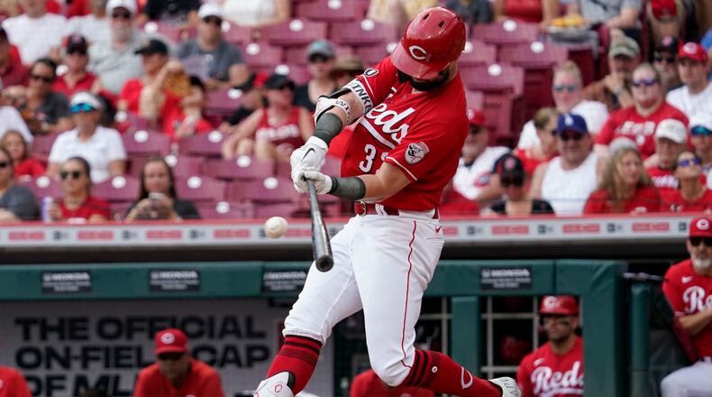 Cincinnati Reds' Jesse Winker hits a single during the first inning of a baseball game against the Pittsburgh Pirates in Cincinnati, Sunday, Aug. 8, 2021. (AP Photo/Jeff Dean)