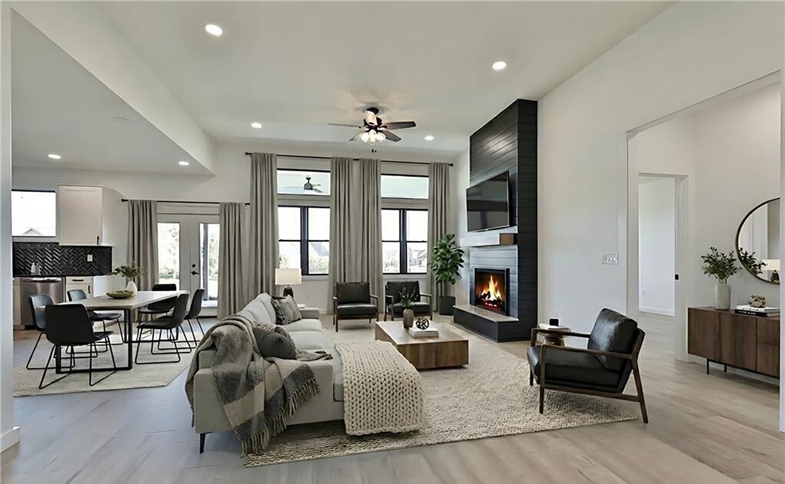 The living room is open to the dining room and kitchen and has a floor to ceiling electric fireplace, recessed lighting and a ceiling fan. CONTRIBUTED
