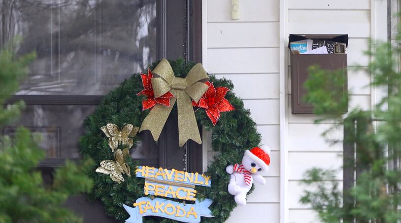 A wreath has been left on the front door of 1934 Kensington Drive in Dayton. Takoda Collins, 10, was rushed to Dayton’s Children’s Hospital on Dec. 13 and was pronounced dead after his father Al-Mutahan McLean called police to say he found the boy unresponsive in their Kensington Drive home. McLean, 30, faces charges in Montgomery County Common Pleas Court in connection to what law enforcement described in court records as “extreme” child abuse against Takoda. LISA POWELL / STAFF