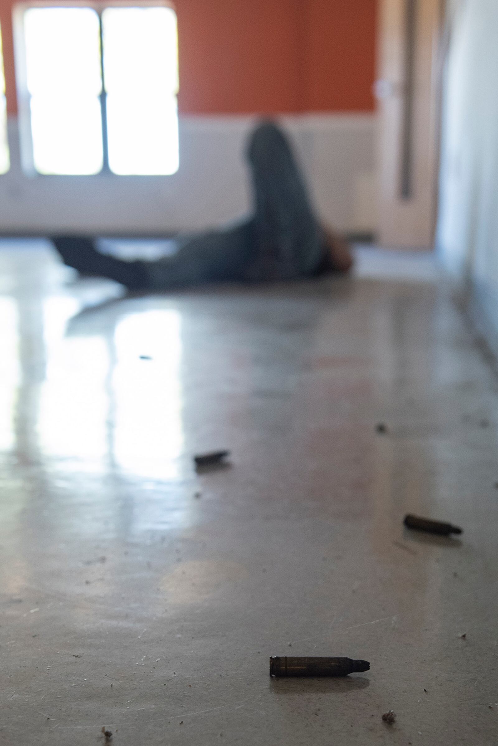 Spent bullet casings lay on the floor near Tech. Sgt. Ian Guthridge of the 88th Security Forces Squadron, who played the role of “active shooter” during an exercise Aug. 18 at Wright-Patterson Air Force Base. U.S. AIR FORCE PHOTO/WESLEY FARNSWORTH
