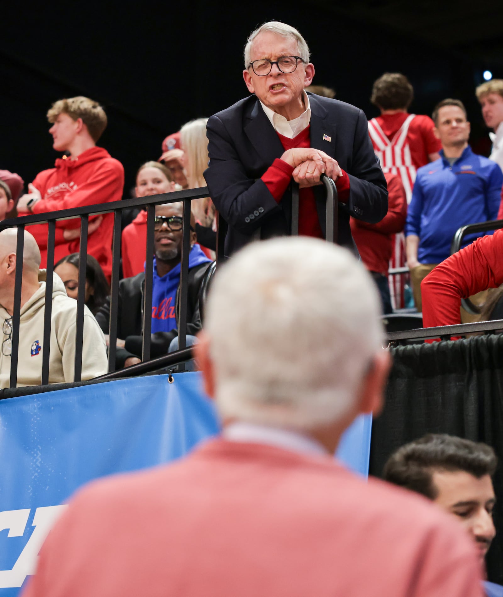Gov. Mike DeWine yells down to Hal McCoy before an NCAA First Four game between Miami and Southern Methodist University on Wednesday, March 18 at University of Dayton Arena. BRYANT BILLING / STAFF