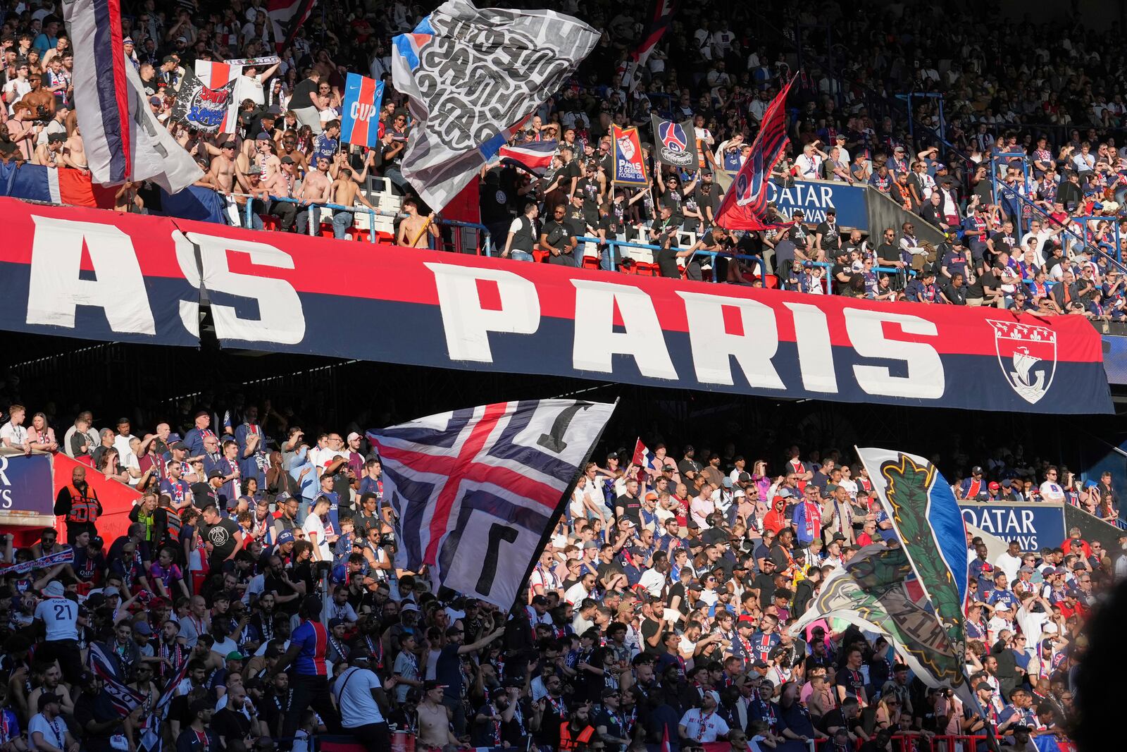 PSG's supporters celebrate winning the French League One championship title after the soccer match between Paris Saint-Germain and Angers at Parc des Princes stadium in Paris, Saturday, April 5, 2025. (AP Photo/Michel Euler)
