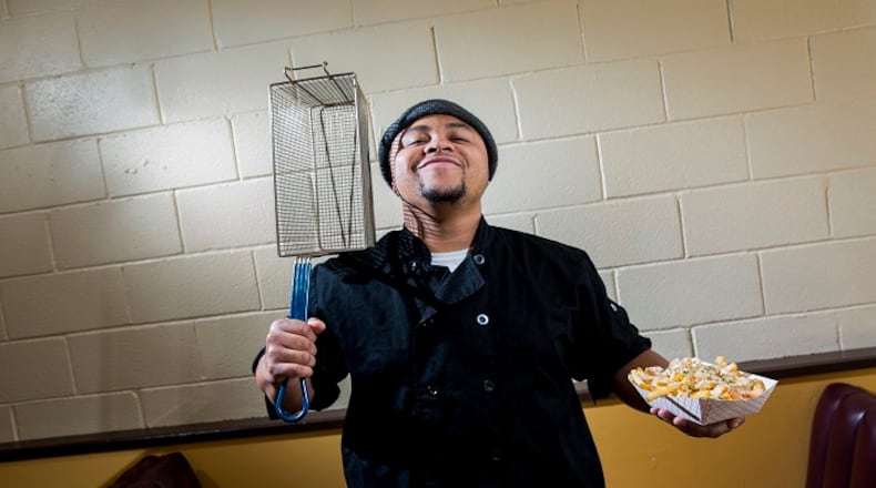 Craig Batiste, aka "Mr. Fries Man," is photographed with his first creation, lemon garlic shrimp fries ($11), inside his new restaurant on March 24, 2017 in Gardena, Calif. Starting out as a pop-up, Batiste would post on Instagram, receive orders and set-up around Gardena for patrons to pick up orders. A food-truck was short-lived, catching fire only after owning it for a couple months. (Jay L. Clendenin/Los Angeles Times/TNS)