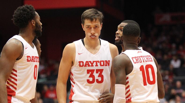 Dayton’s starters, including Ryan Mikesell, center, huddle during an exhibition game against North Florida on Friday, Nov. 2, 2018, at UD Arena.