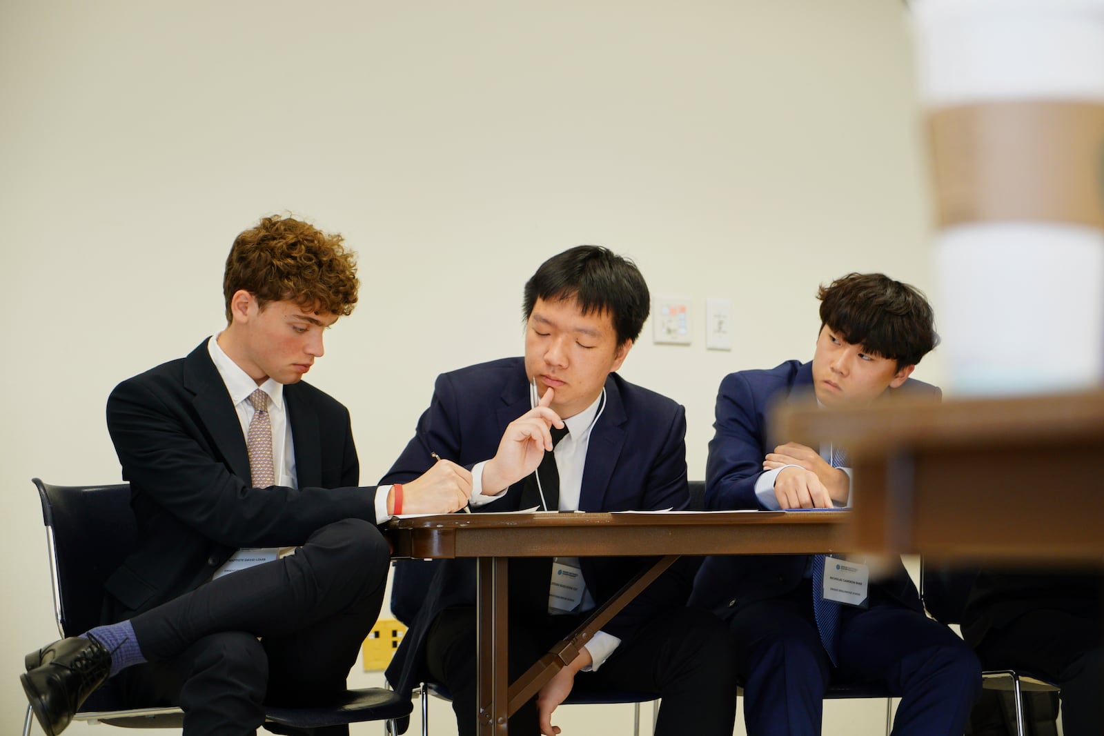 Students from the Dwight-Englewood School in New Jersey confer during a quarterfinal round of the National High School Ethics Bowl in Chapel Hill, N.C., on Sunday, April 13, 2025. (AP Photo/Allen G. Breed)