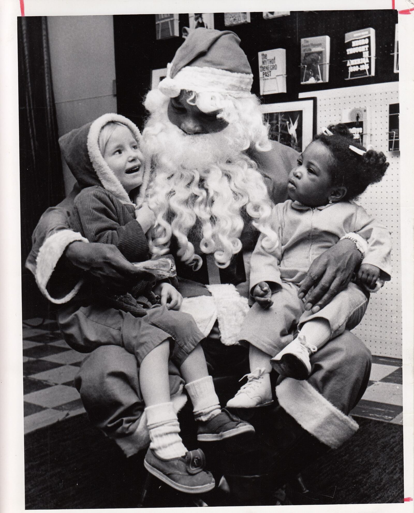 The caption of this photo dated Dec. 22 read: "(W.S.) McIntosh  plays Santa for granddaughter  Tunnetta (actually Tynnetta) (R). Girl on the left is Denise Killingsworth_ Photo by Steinbrunner.  The headline read: "No Racial Overtones."