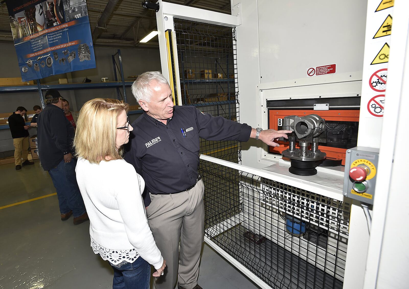 Jack Palmer, owner of Palmer Manufacturing, shows his wife, Marti, a new grinding machine during a tour of their new facility follow a ribbon cutting. The new expansion is part of a joint venture with Maus, an Italian firm, that may lead to new jobs. Bill Lackey/Staff