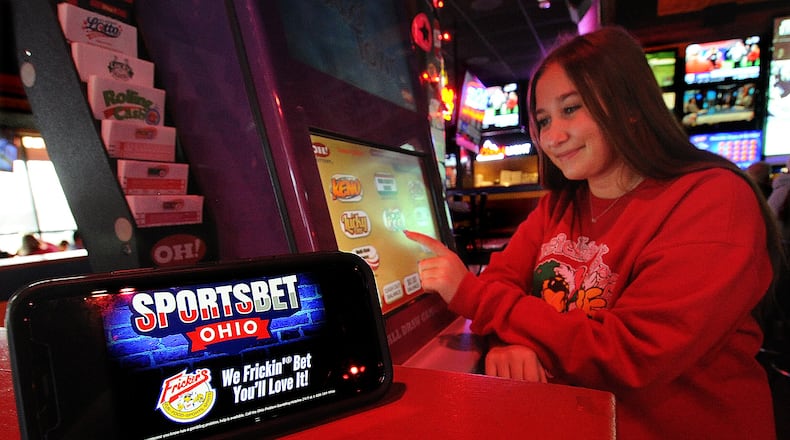 Lily Spahr sits at a gaming kiosk at the Fricker's in Centerville Wednesday Dec. 28, 2022. The Ohio Legislature passed a sports betting bill in December, 2021, and the Ohio Casino Control Commission announced in June of 2022 that it would launch sports gambling Jan. 1, 2023. MARSHALL GORBY\STAFF