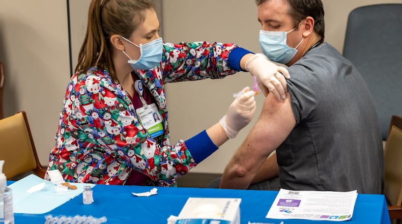 Dr. Jeremy Moore, the emergency department medical director at Miami Valley Hospital North, was one of the first Dayton-area residents to receive the federally approved coronavirus vaccine when he got his first shot on Dec. 22, 2020. Photo submitted by Premier Health.