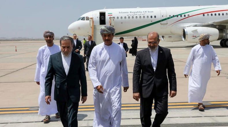 FILE - In this photo released by the Iranian Foreign Ministry, Iranian Foreign Minister Abbas Araghchi, left, is welcomed by an unidentified Omani official, center, upon his arrival at Muscat, Oman, for negotiations with U.S. Mideast envoy Steve Witkoff, as Iranian Ambassador to Oman Mousa Farhang walks at right, May 11, 2025. (Iranian Foreign Ministry via AP, File)