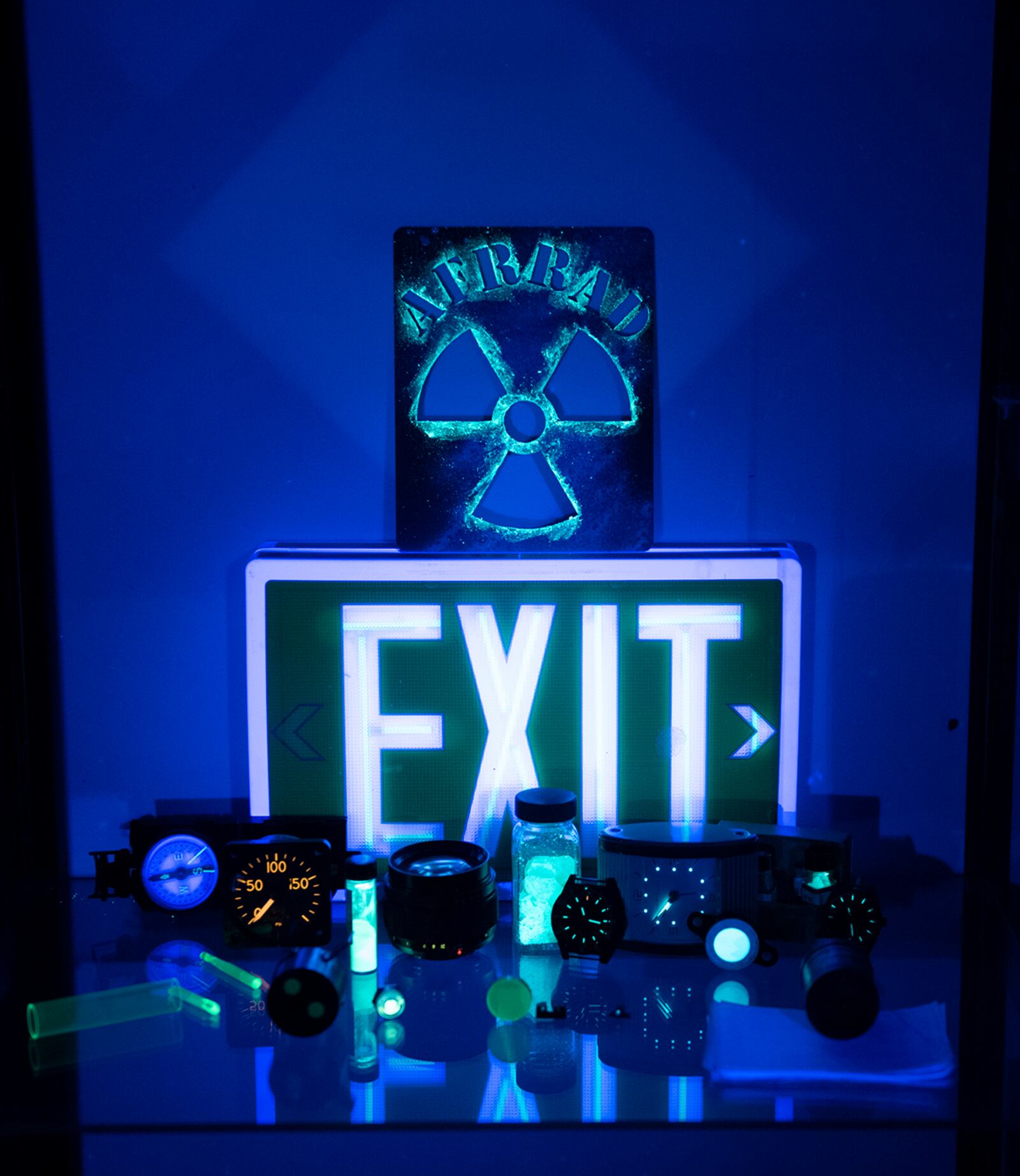 A collection of items glow under a black light at the Air Force Radioactive Recycling and Disposal facility Dec. 1, 2021, at Wright-Patterson Air Force Base. U.S. AIR FORCE PHOTO/JAIMA FOGG