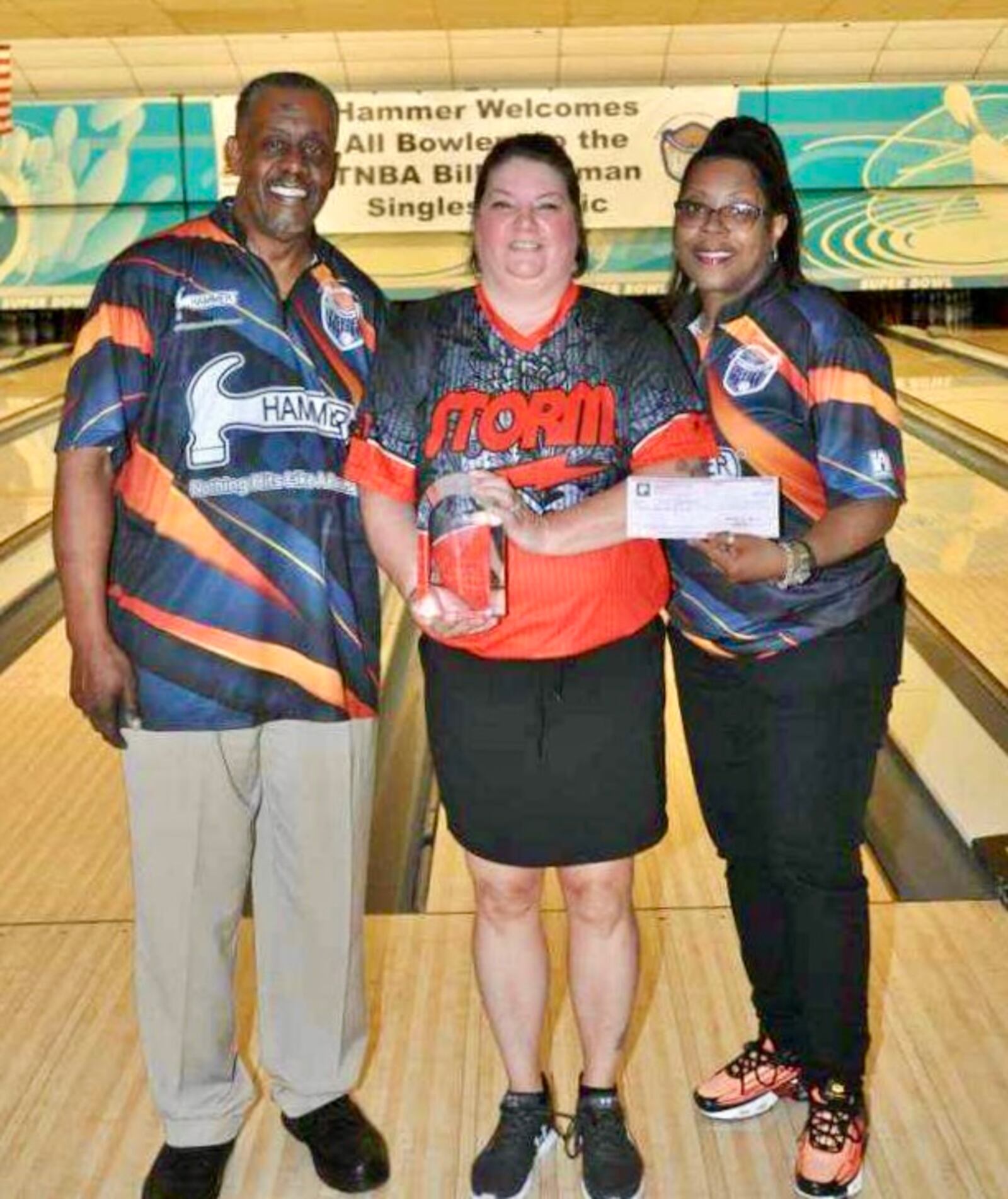 Ann Coleman (center) celebrates her win with interim tournament director Jerome Lewis and assistant tournament director Amy Daniels - Contributed