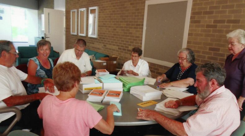 Lifelong Learning Institute volunteers work on numerous committees and tasks, such as mailing course catalogs and event information to members. (Handout/Lifelong Learning Institute)