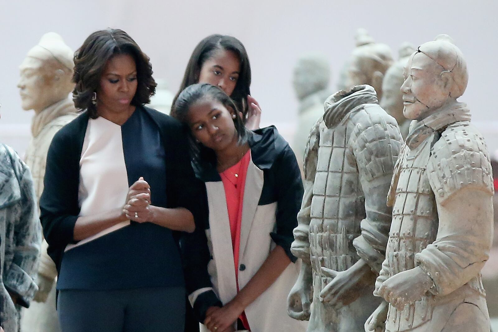XI'AN, CHINA - MARCH 24: First Lady Michelle Obama with her daughters Malia Obama and Sasha Obama visit Museum of Terracotta Warriors during a visit to the historic excavation site on March 24, 2014 in Xi'an, China. Michelle Obama's one-week-long visit in China will be focused on educational and cultural exchanges. (Photo by Feng Li/Getty Images)