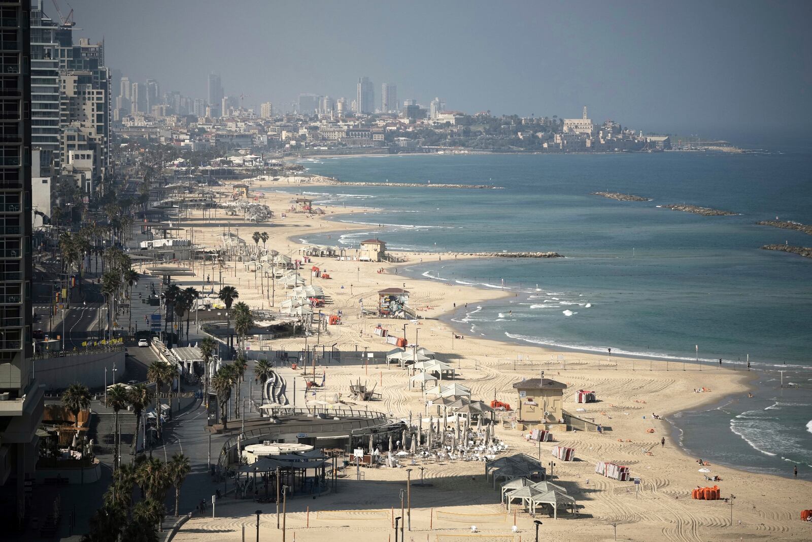 A general view shows the mostly empty beachfront in Tel Aviv, Friday, June 13, 2025. (AP Photo/Leo Correa)