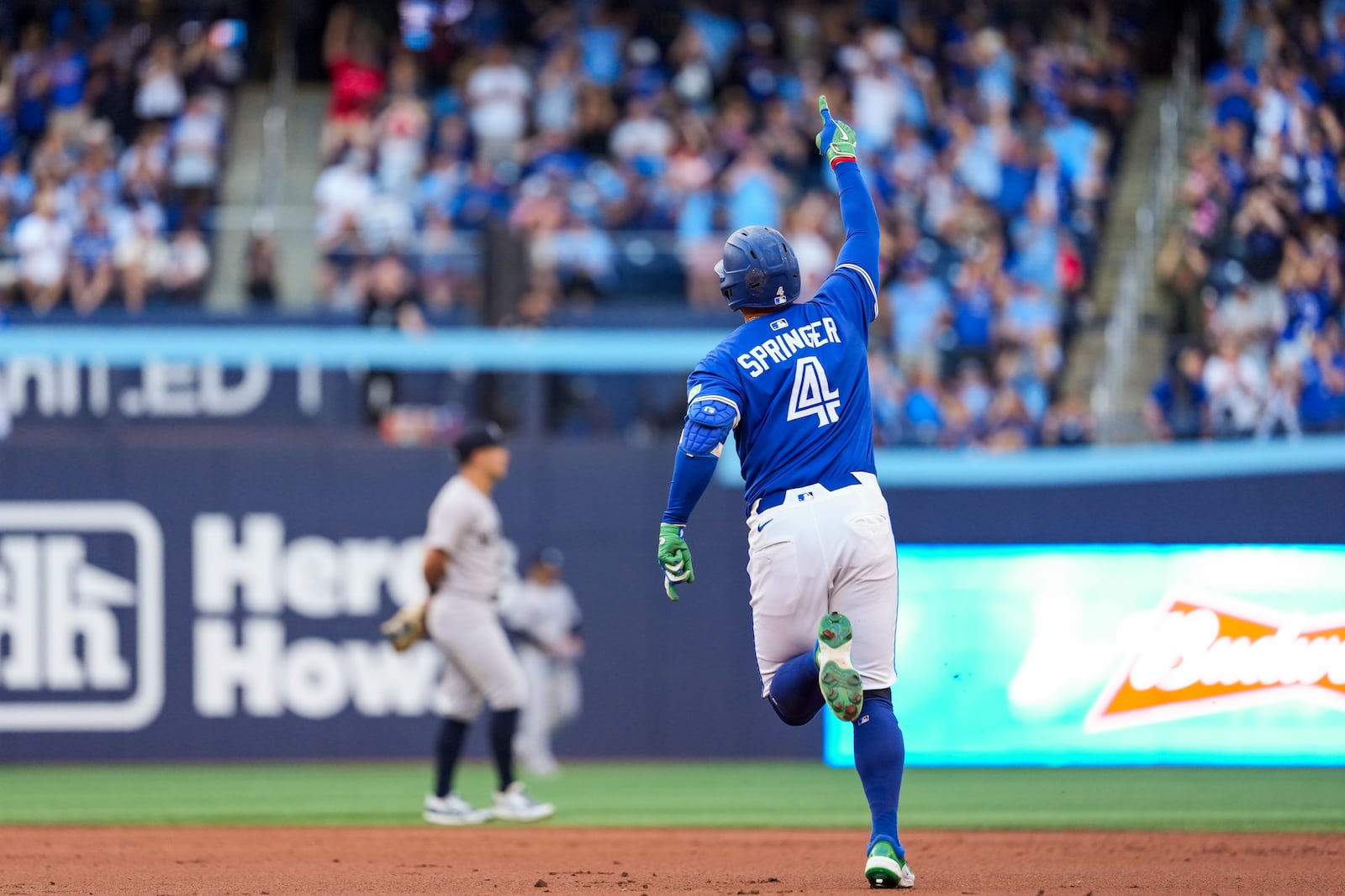 Toronto Blue Jays' George Springer (4) celebrates his two-run home run against the New York Yankees during third inning MLB baseball action, in Toronto on Thursday, July 3, 2025. (Thomas Skrlj/The Canadian Press via AP)