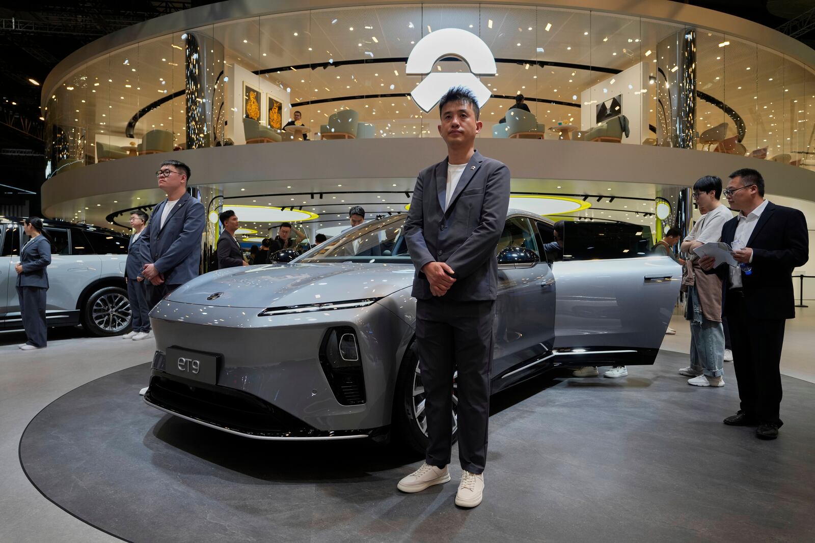 Staff from Chinese automaker Nio waits for visitors at their booth during the Shanghai auto show on Wednesday, April 23, 2025. (AP Photo/Ng Han Guan)