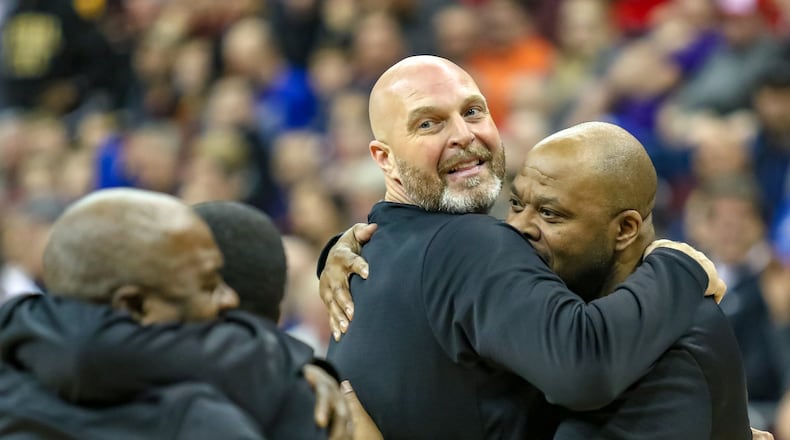 Trotwood-Madison High School boys basketball coach Rocky Rockhold hugs Rams assistant coach Tony Clemens after the Rams beat Columbus South 77-73 in the Division II state championship game at the Ohio State University Jerome Schottenstein Center in Columbus. CONTRIBUTED PHOTO BY MICHAEL COOPER