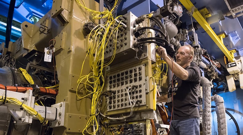 Scott Degenhardt, an instrument technician, uses a multimeter while checking equipment in an Arnold Engineering Development Complex Engine Test Facility test cell at Arnold Air Force Base between test runs of an F135 engine. The F135 is undergoing Accelerated Mission Testing in the AEDC facility and is used to power the F-35 Joint Strike Fighter Lightning II. (U.S. Air Force photos/Jill Pickett; This image was altered by obscuring a badge for security purposes)