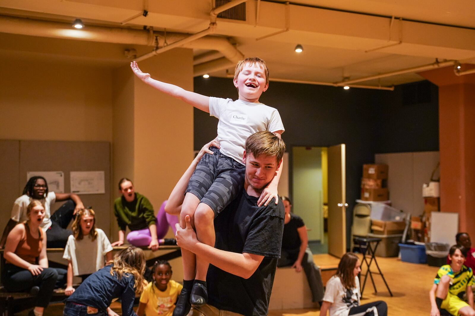 Lucas Koerner carries Charlie MacPherson (The Great Rumpus Cat) to his celebrated entrance. PHOTO BY MUSE MACHINE