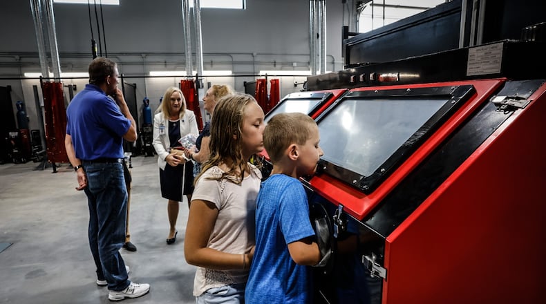 Nate and Sara Dilk check out the Wayne High School Career Tech Center's welding classroom. The new facility will teach three trades; construction, HVAC and construction. JIM NOELKER/STAFF