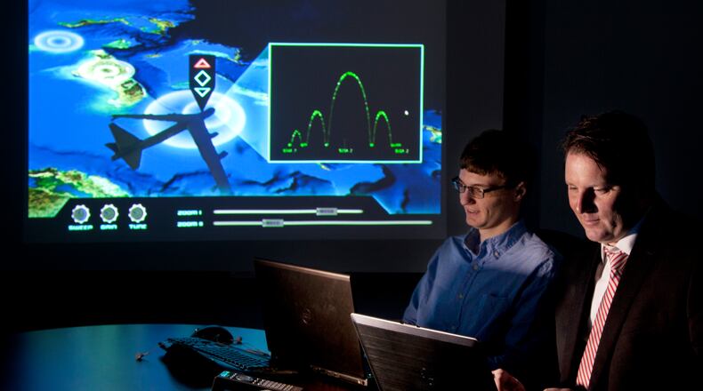 APTIMA computer programmer Charlie Dickens, left, and director of Dayton operations Ronald Storm work on a new training program they plan to offer to the Department of Defense. Aptima has grown considerably since coming to the Dayton market a few years ago. It opened in 2007 with three people; now it has 17, with a payroll of $1.4 million. It works with Wright State and the AFRL to develop simulation and live virtual training environments. One aspect of the company's work locally: Decoding cognitive overload and the limits of warfighters engaged in critical missions. TY GREENLEES/STAFF