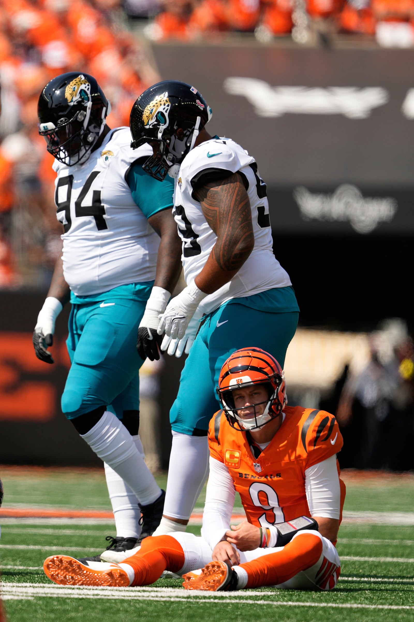 Cincinnati Bengals quarterback Joe Burrow (9) goes down after being tackled during the first half of an NFL football game against the Jacksonville Jaguars, Sunday, Sept. 14, 2025, in Cincinnati. (AP Photo/Carolyn Kaster)