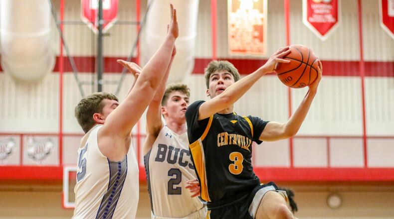 Centerville High School’s Matt Pearce drives to the hoop against Xenia’s Jate Bradley and Gavin Gerhardt during their Division I sectional final game on Friday night at Trotwood-Madison High School. Pearce had 23 points in the Elks’ 63-51 victory. CONTRIBUTED PHOTO BY MICHAEL COOPER