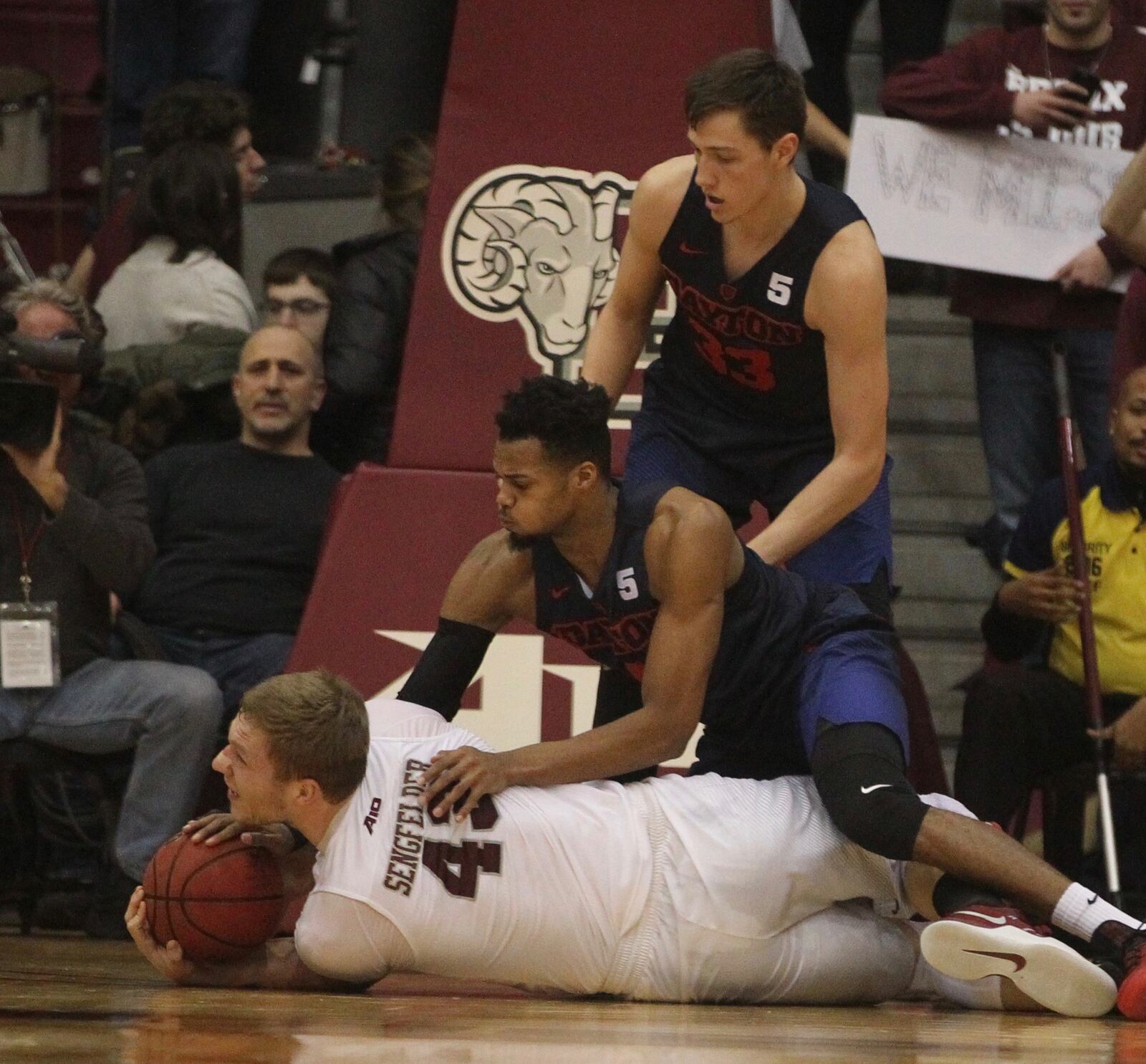 Dayton’s Charles Cooke and Ryan Mikesell compete for a loose ball against Fordham’s Christian Sengfelder on Tuesday, Jan. 31, 2017, at Rose Hill Gym in Bronx, N.Y.