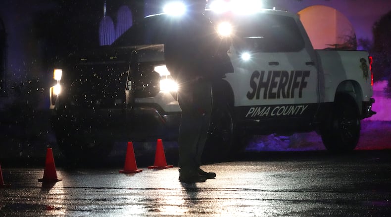 Pima County Sheriff block a road near Nancy Guthrie's home in Tucson, Ariz. on Friday, Feb. 13, 2026. (AP Photo/Ty ONeil)