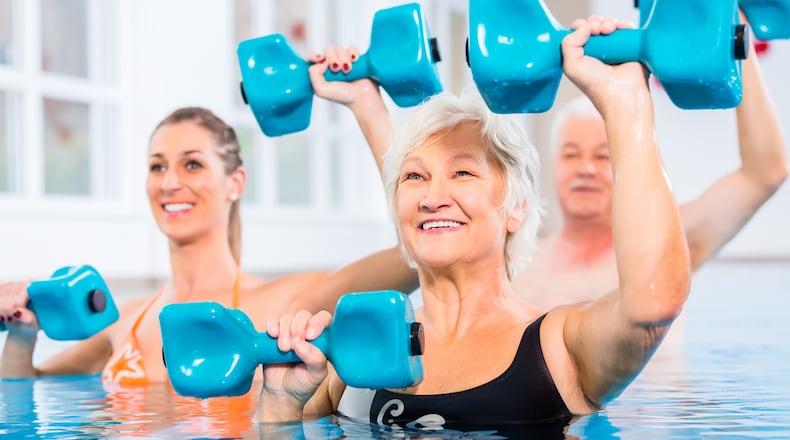 Water weights are foam barbells that create resistance under water. Start with the arms at the sides. Grip the bars of the water weights with the palms facing up. Raise the forearms to the level of the water, keeping the elbows close to the body and the wrists straight. iSTOCK/COX