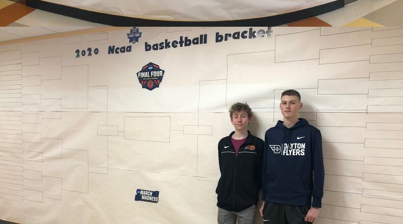 Liam Gluck, left, and Lance Caswell, right, pose with the NCAA tournament bracket they helped create at Jacob Coy Middle School. Submitted photo