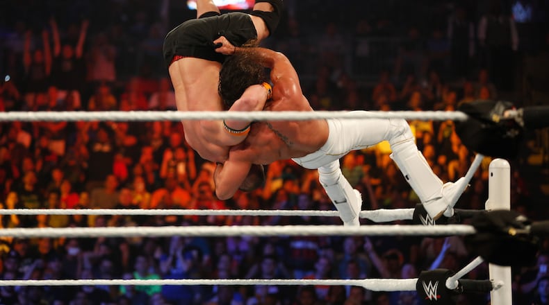NEW YORK, NY - AUGUST 23: Seth Rollins and John Cena battle it out at the WWE SummerSlam 2015 at Barclays Center of Brooklyn on August 23, 2015 in New York City. (Photo by JP Yim/Getty Images)