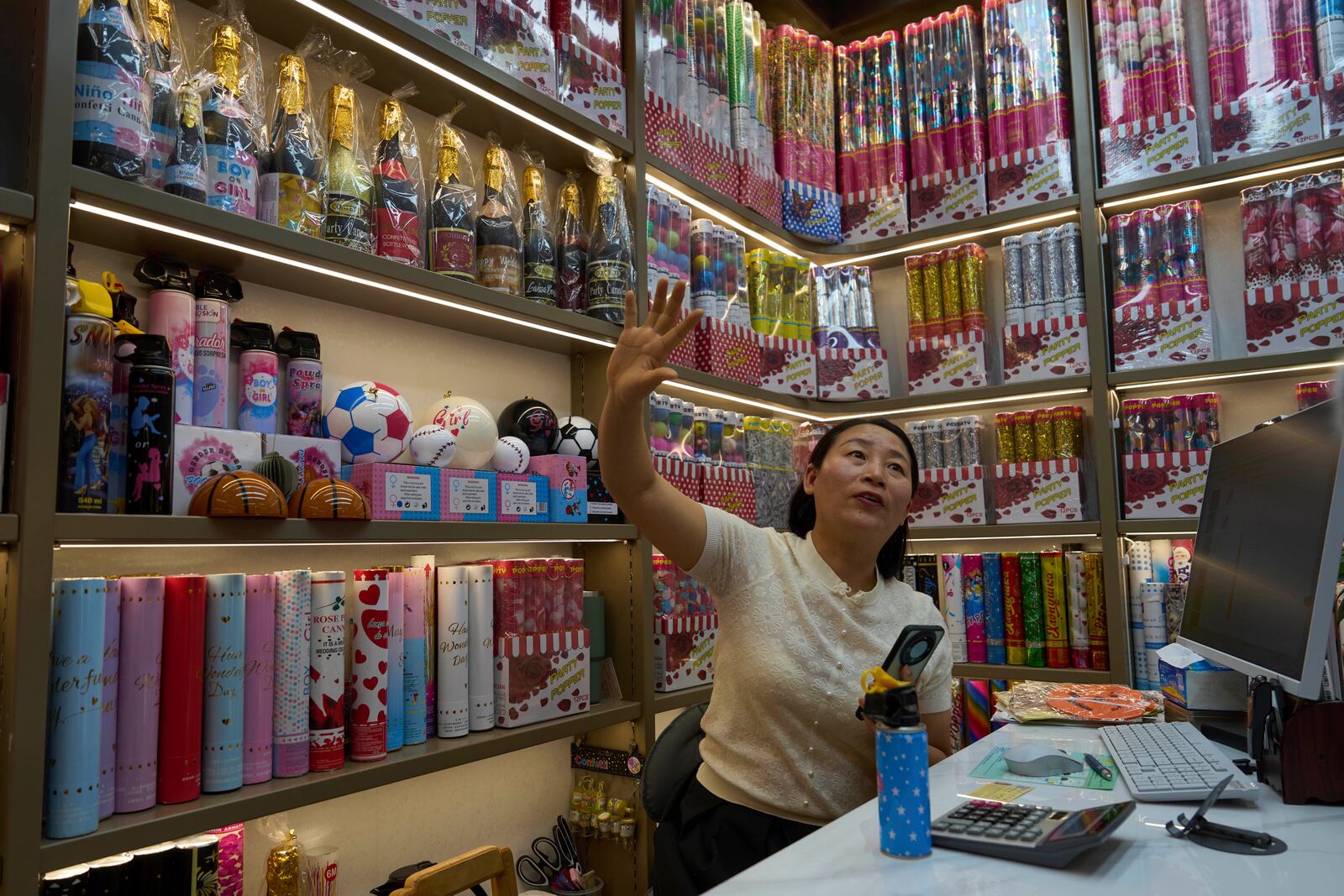 Jiang Jiayu, owner of Yiwu Jiayu Festive Supplies Co. an exporter of party poppers, speaks at the Yiwu International Trade Market in Yiwu, eastern China's Zhejiang province on Thursday, April 10, 2025. (AP Photo/Ng Han Guan)