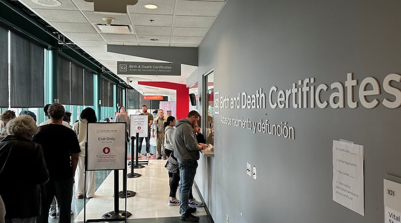 Customers stand in line to get birth and death certificates at the Columbus Public Health Department in Columbus, Ohio, on Tuesday, March, 10, 2026. (AP Photo/Julie Carr Smyth)