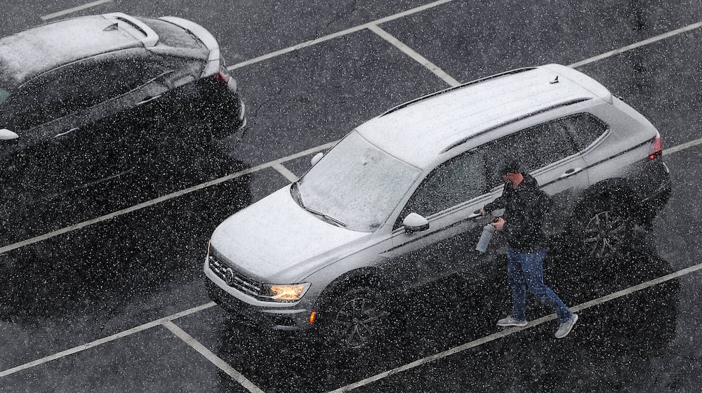 Workers have to remove snow from their cars Friday, Feb. 16, 2024 before going home. MARSHALL GORBY\STAFF
